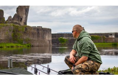 man fishing by lake